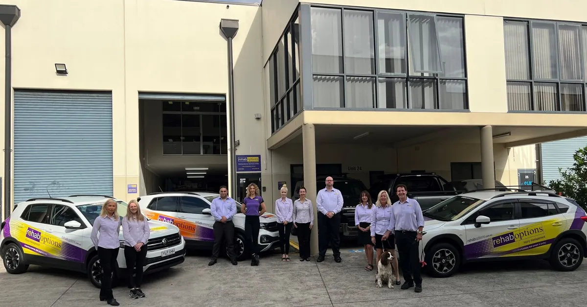 Branded Rehab Options vehicles parked outside an office