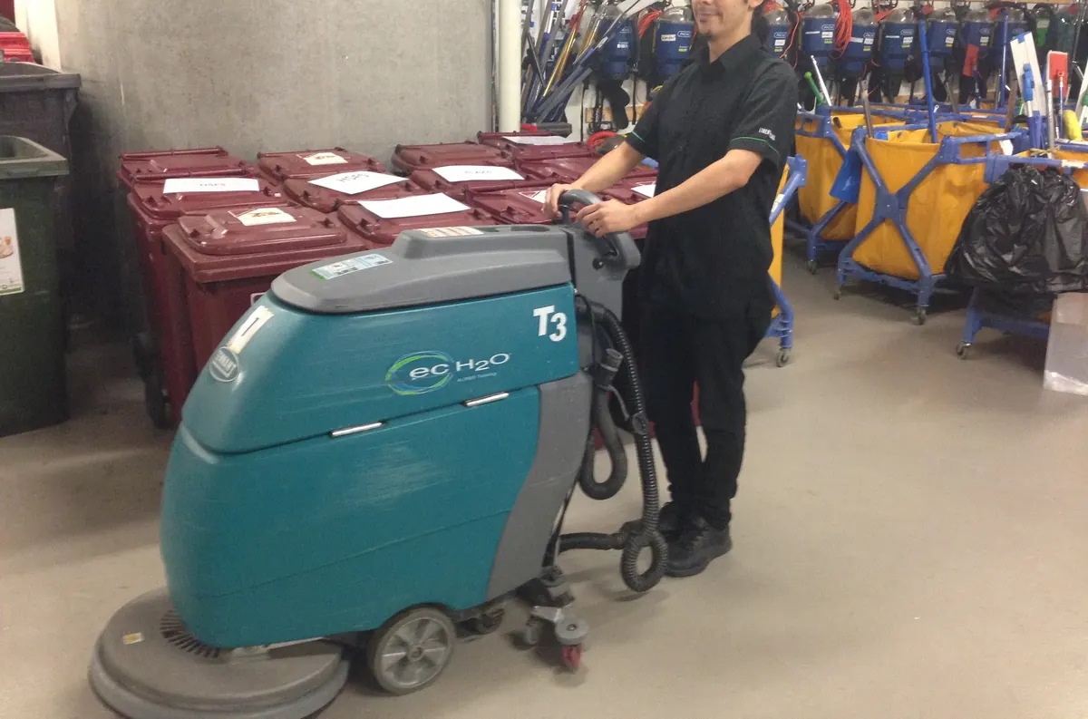 A floor-care machine being operated on a client site